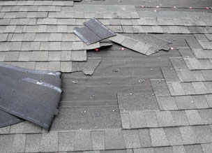 Damaged shingles in need of roof repair