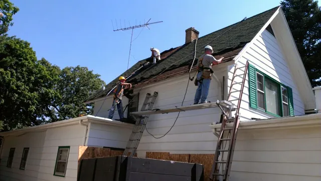 DFC Roofing crew replacing a storm-damaged roof in the Elgin area